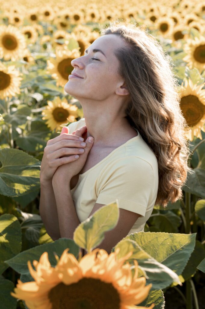 Jeune femme souriante dans un champ de tournesols